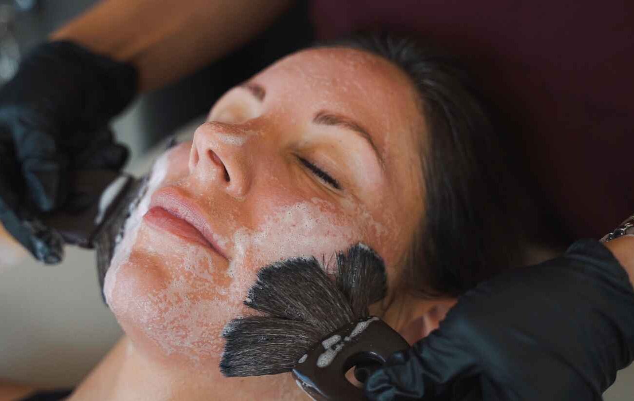 Registered nurse performing an iS Clinical facial at Sisä Skincare in Freshwater